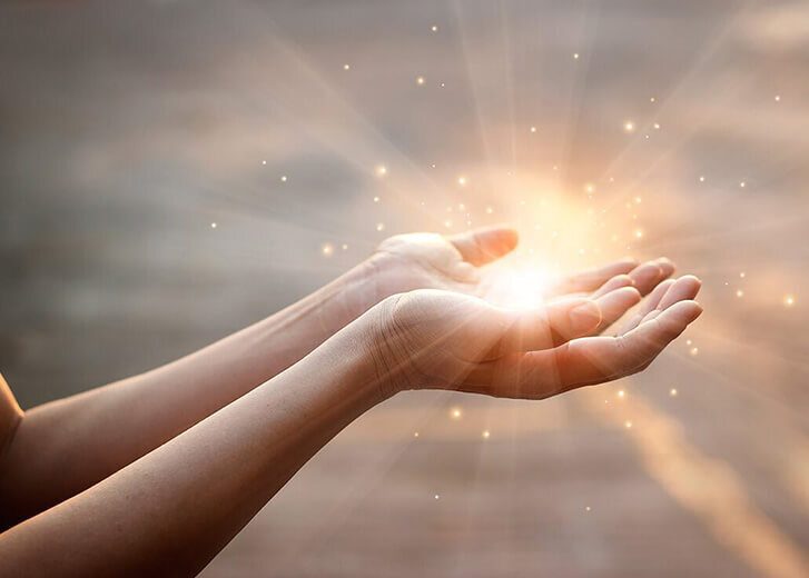 Woman hands praying for blessing from god on sunset background